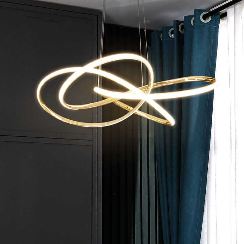 Gold contemporary chandelier with sleek lines, illuminating a stylish indoor space with elegant design.
