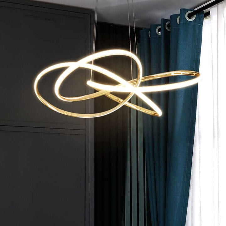 Gold contemporary chandelier with sleek lines, illuminating a stylish indoor space with elegant design.