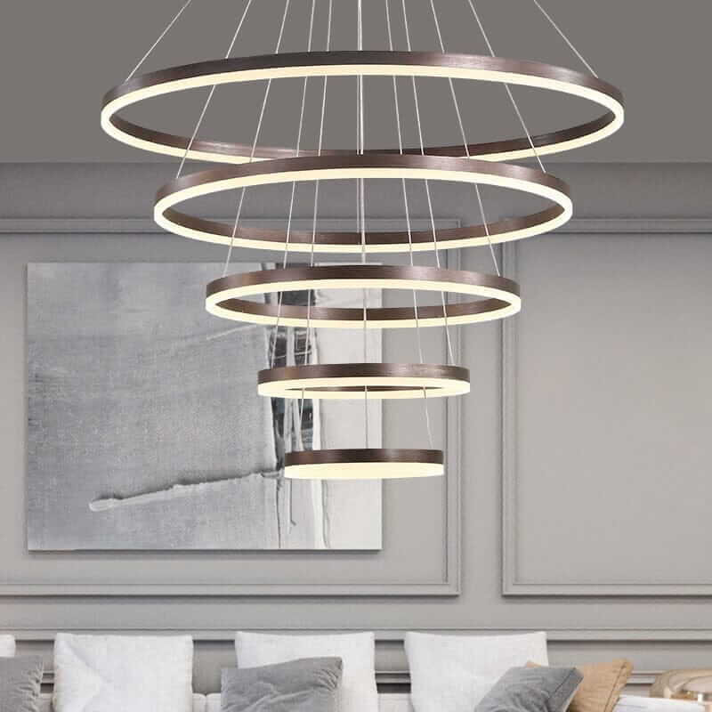 Gold and black chandelier with interconnected rings, adding elegance to modern decor.