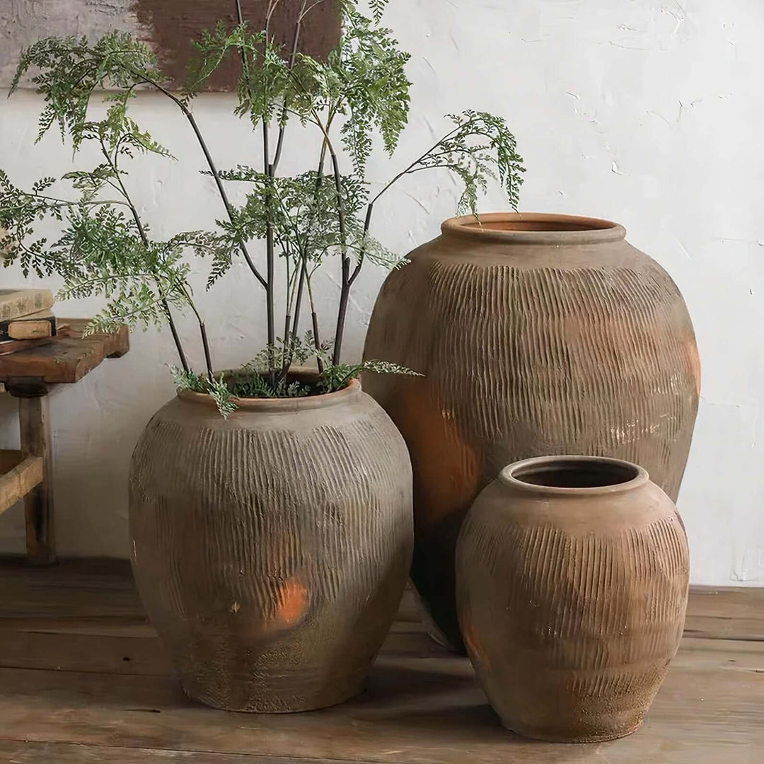 Flower Vases - Ceramic Vase showcased with tall, large decorative vases displaying greenery in rustic design.