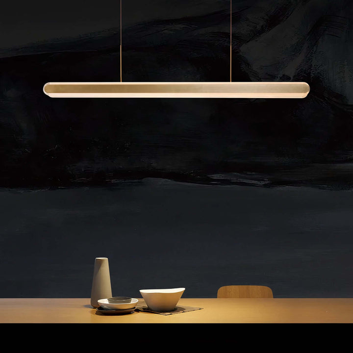 Linear Chandelier - Gold Chandelier illuminating a dining table with elegant minimalism.