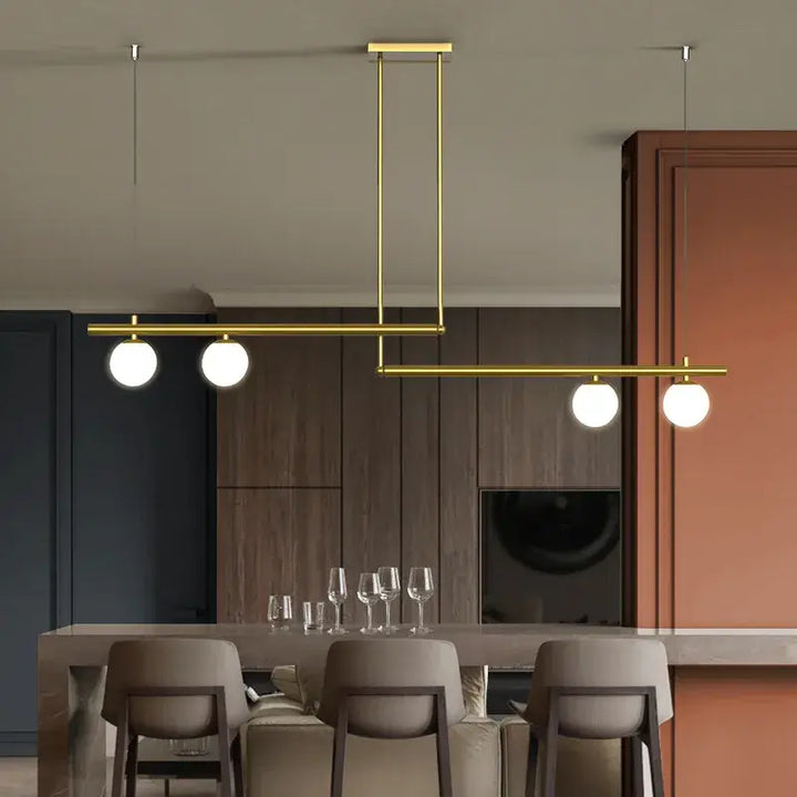 Black and gold modern chandelier with frosted globes, perfect for kitchen islands and contemporary dining spaces.