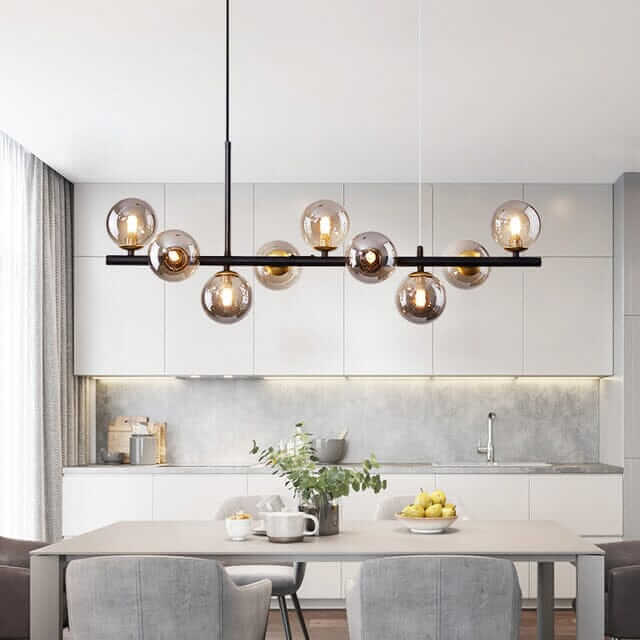 Stylish Bubble Chandelier illuminating a modern kitchen dining area with grey chairs and a sleek table.