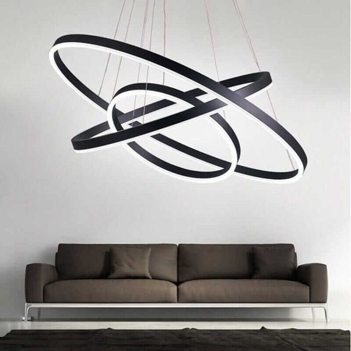 Gold and black chandelier with interconnected rings, enhancing modern living room decor.