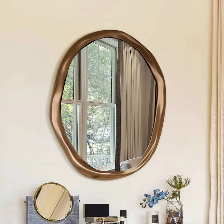 Gold Mirror - Circle Mirror hanging on a wall, enhancing the room's natural light and modern decor.