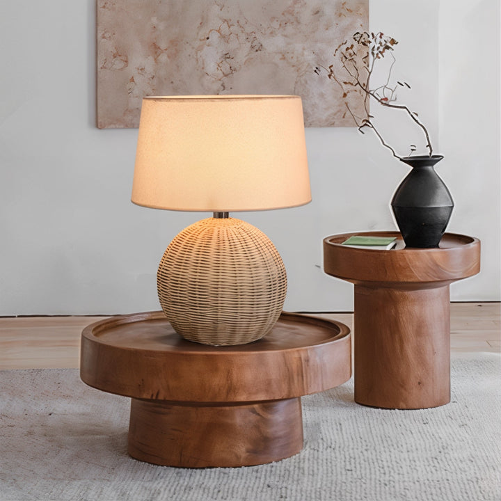 Mid Century Table Lamp - Traditional Yet Contemporary on a wooden table, showcasing its rattan shade and warm glow.