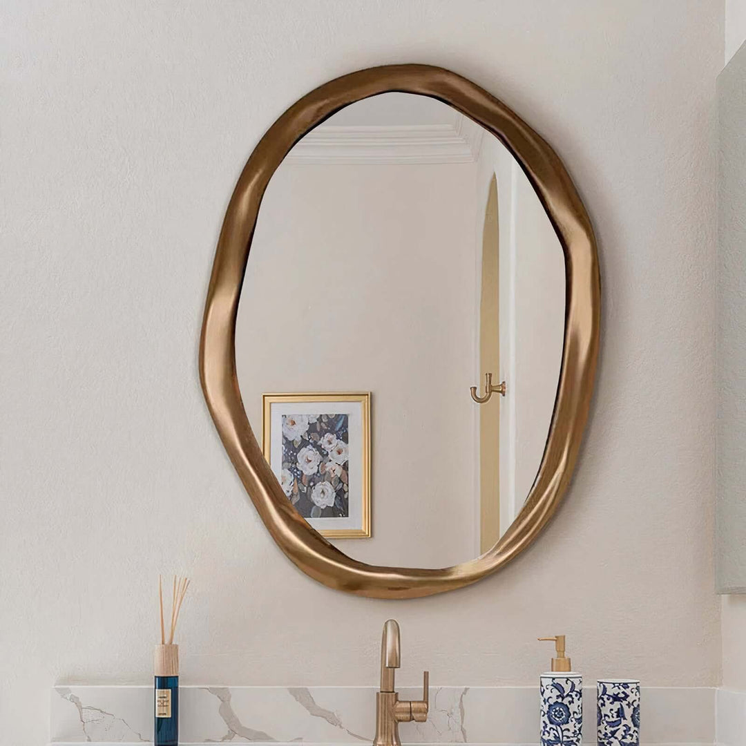 Gold Mirror - Circle Mirror hanging above a sink, perfect for bathroom décor and reflecting light in living spaces.
