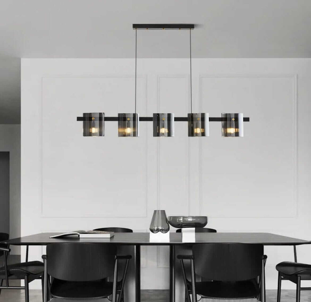 Modern LED chandelier illuminating a stylish dining area with sleek black chairs.