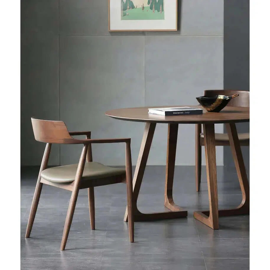 Solid Wood Dining Chair - Dining Room Chair at a stylish dining table setup, featuring a wooden base and leather seat.