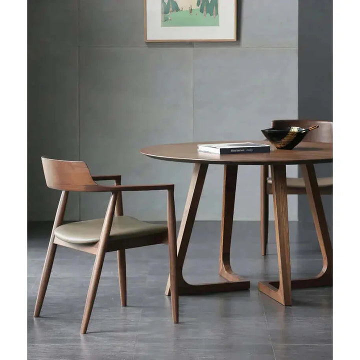 Solid Wood Dining Chair - Dining Room Chair at a stylish dining table setup, featuring a wooden base and leather seat.
