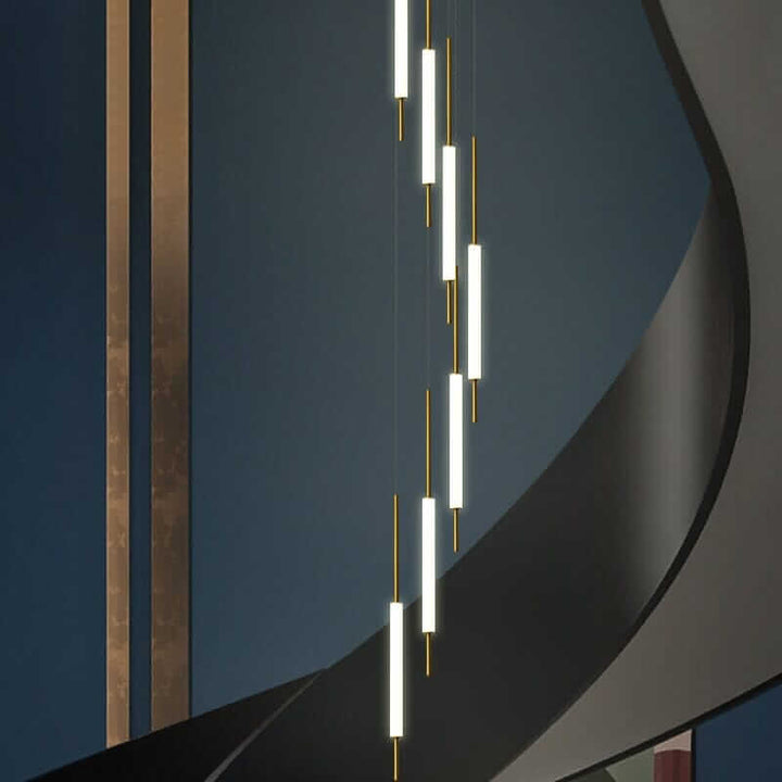 Elegant staircase chandelier with modern design, featuring glowing light tubes and gold accents, enhancing a stylish interior.