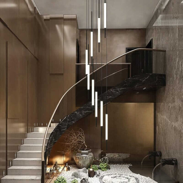 Elegant staircase with modern chandelier illuminating stylish interior design.