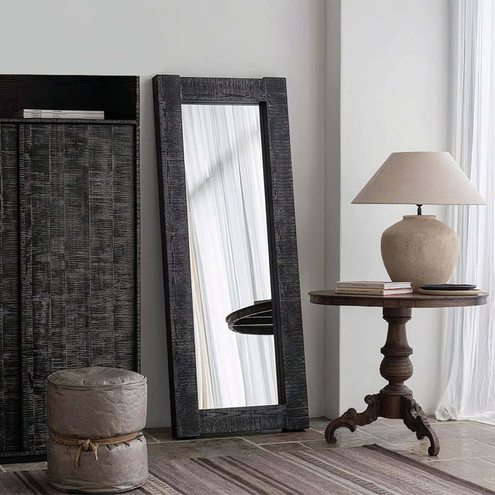 Vanity Mirror - Floor Mirror positioned alongside a wooden table and lamp in a stylish interior setting.