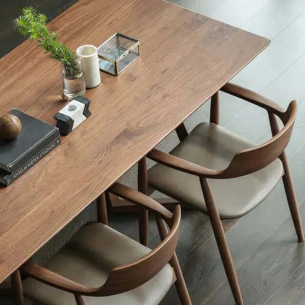 Wood And Leather Chair - For Your Dining Room pair at a modern dining table, showcasing a stylish wood base and leather seating.