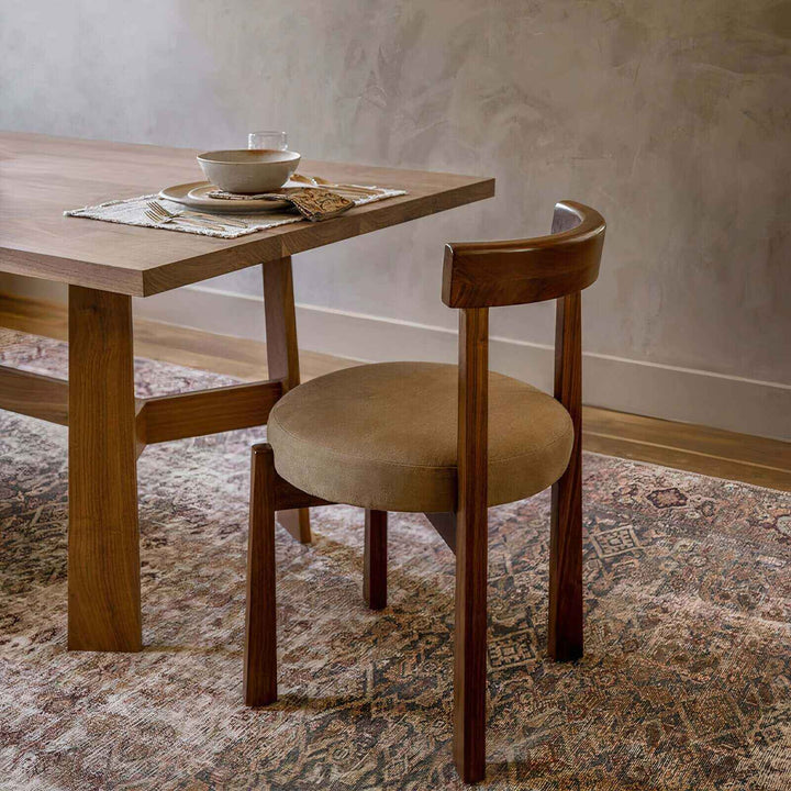 Wood Dining Chair - Natural Beauty with plush cushion beside a dining table in a warm interior setting.
