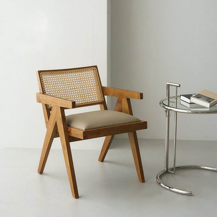 Wood Dining Chair With Cushion - Mid Century Armchair featuring a rattan back and leather seat in a stylish setting.